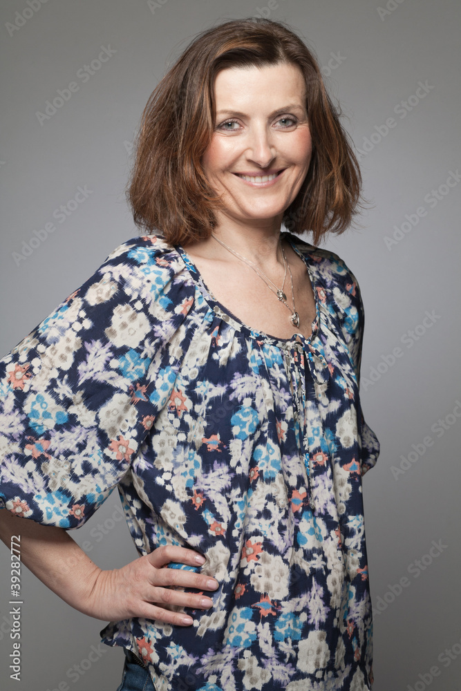 Happy middle age woman posing in studio. Happy middle age woman posing in studio.