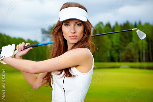 Portrait of an elegant woman playing golf on a green