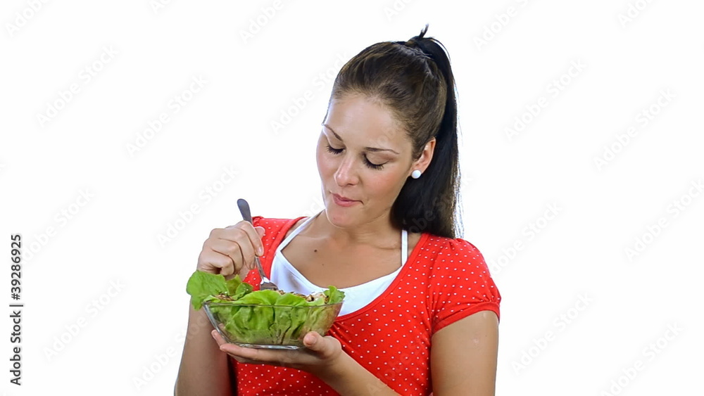 Young women eating chicken wit salad, over white Young women eating chicken wit salad, over white