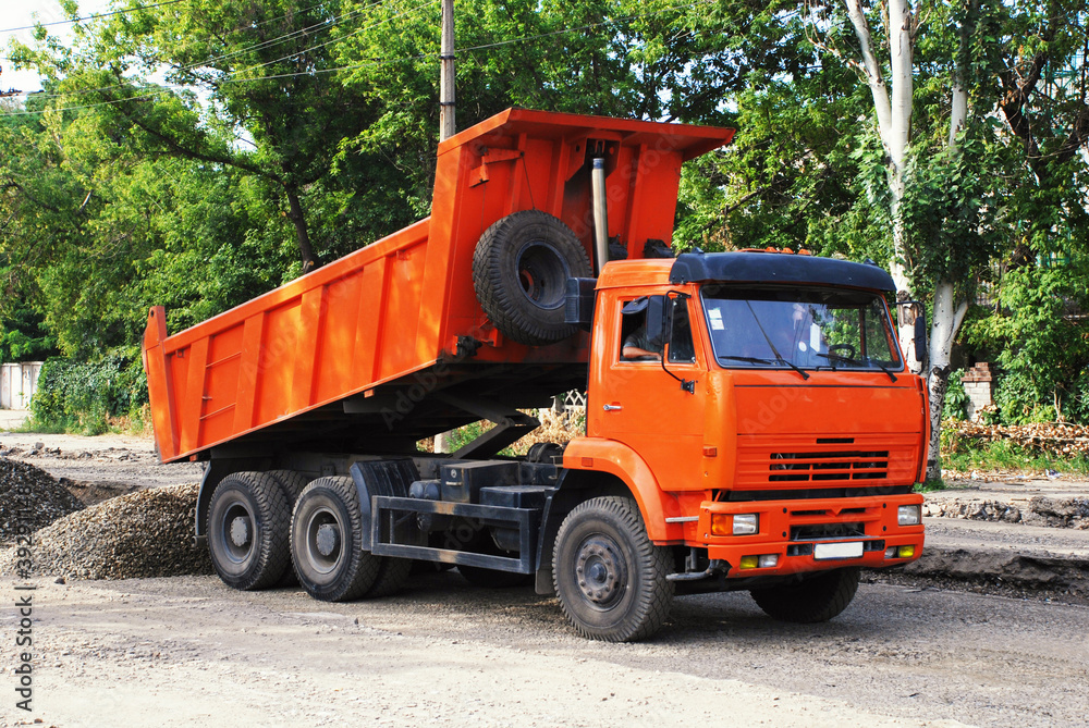 Orange industrial truck on road constraction