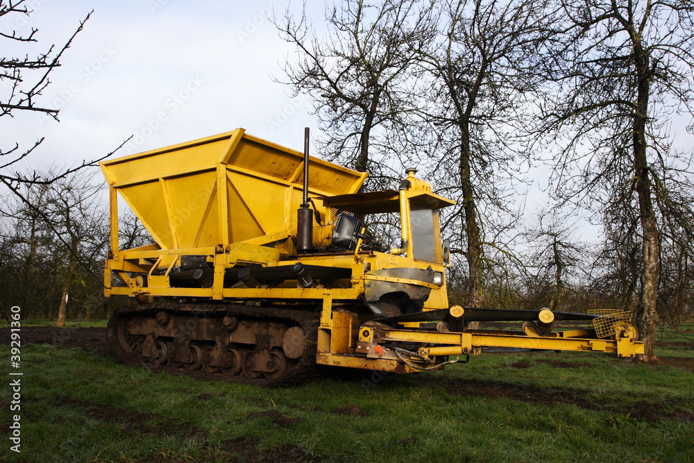 Fototapeta premium Big yellow machine - used for laying drainage stone