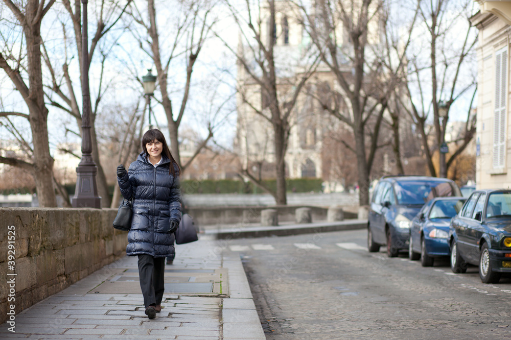 Pretty brunette female tourist walking in Paris