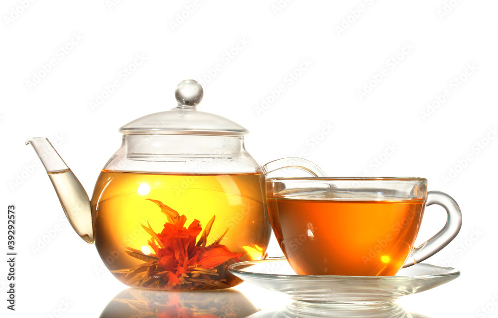 exotic green tea with flowers in glass teapot and cup isolated exotic green tea with flowers in glass teapot and cup isolated