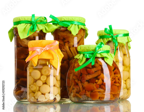Obraz na płótnie delicious marinated mushrooms in the glass jars isolated