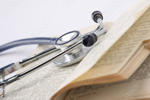 a stethoscope on an opened book, closeup photo