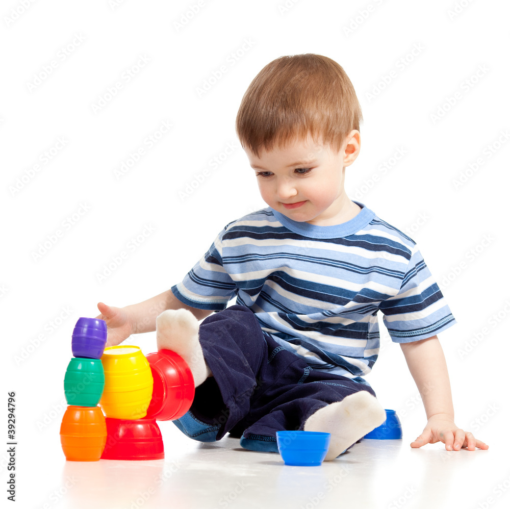 Funny little child is playing with color toys, isolated over whi Funny little child is playing with color toys, isolated over whi