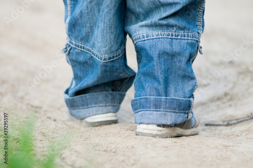 Closeup on a kids feet wearing grey sandals