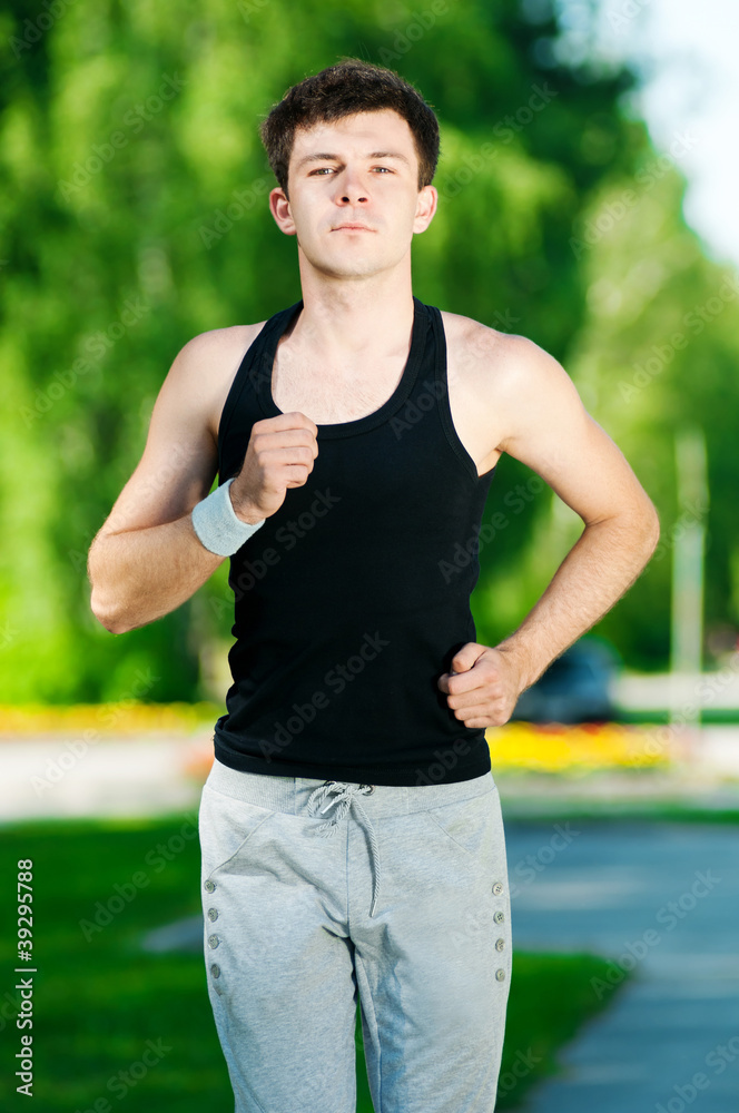 Young man jogging in park Young man jogging in park