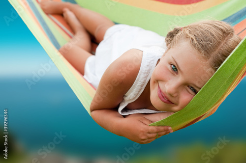 Canvas Print Summer vacation - Lovely  girl resting in colorful hammock