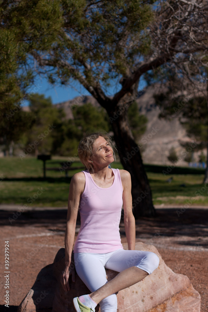 mature womansitting on rock