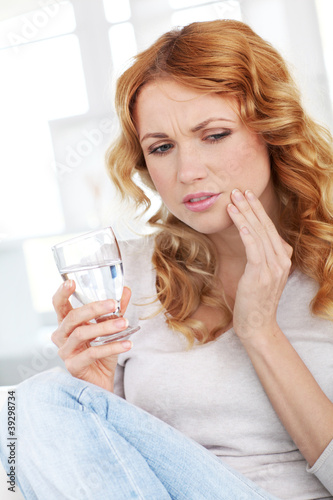 Beautiful blond woman having toothache