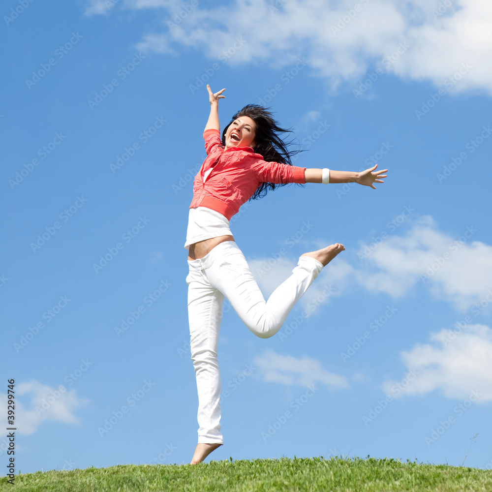 pretty young woman jumping on green grass pretty young woman jumping on green grass
