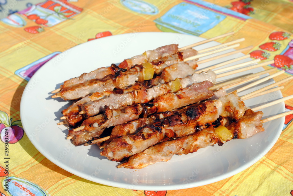cocked pork kabobs grilled on skewers in a plate
