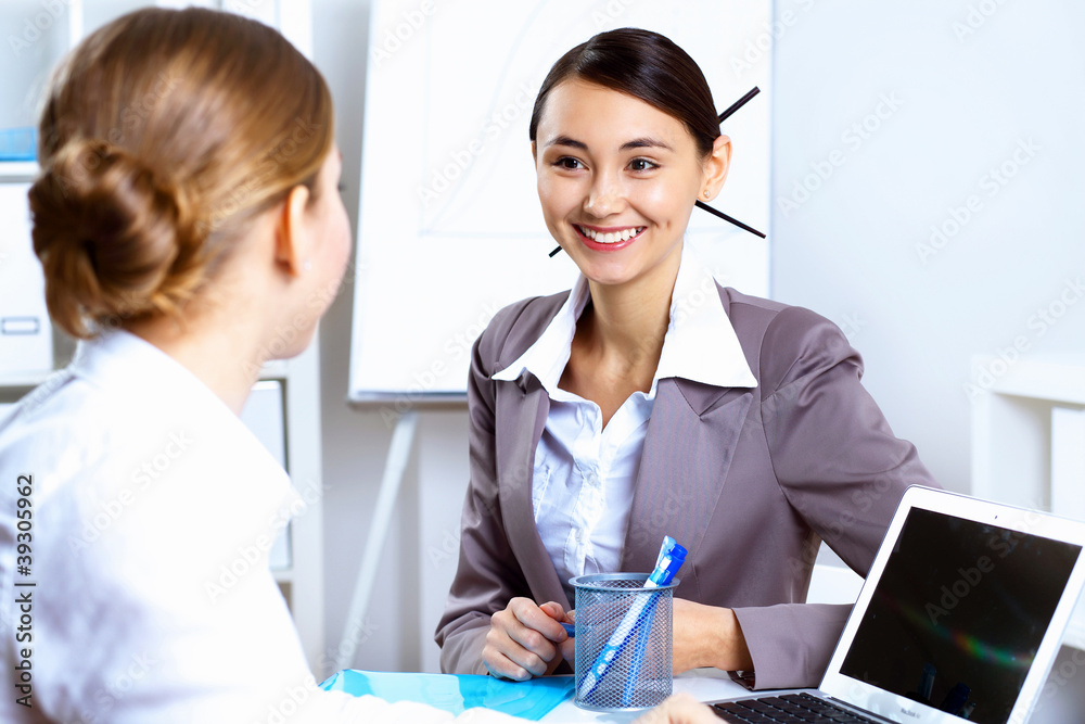 Young women in business wear working in office Young women in business wear working in office