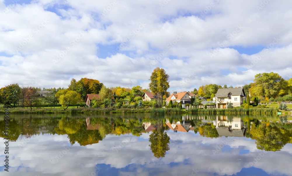 Dream autumn village and its reflection