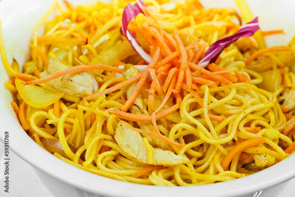 Curry chicken made with carrots, onions and noodles in wok Curry chicken made with carrots, onions and noodles in wok