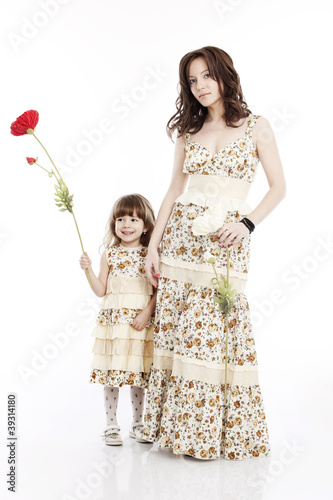 Portrait of mother and little daughter with a flower