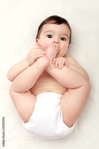 Adorable baby sucking his toes