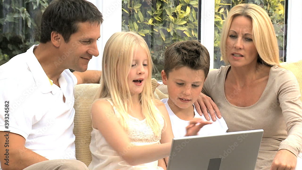 Caucasian Family at Home with Laptop Computer Caucasian Family at Home with Laptop Computer