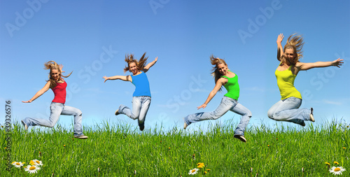 Jumping young girl in blue jeans outdoors