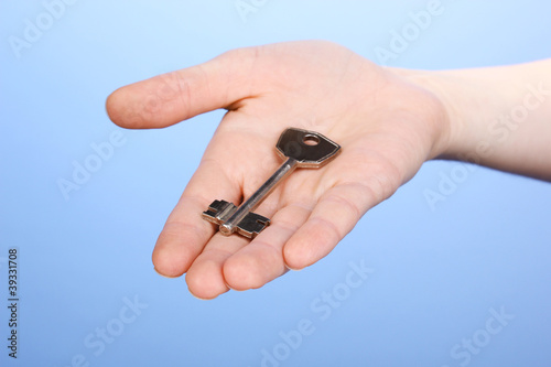 Key in hand on blue background