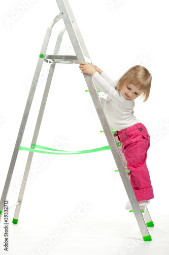 A baby girl walking down the stepladder