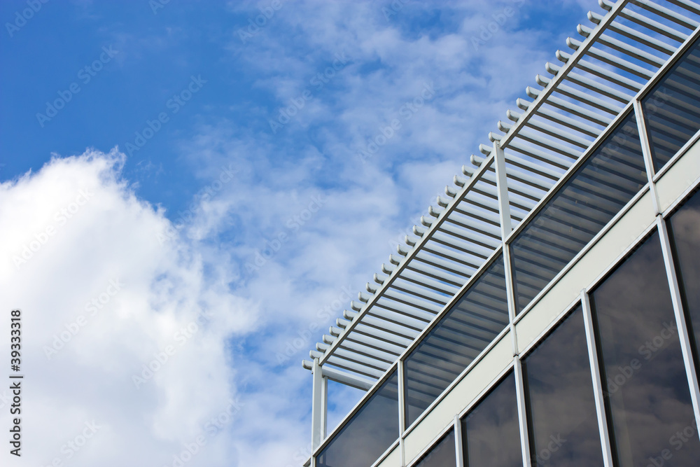 Modern office house. blue glass on a background sky Modern office house. blue glass on a background sky