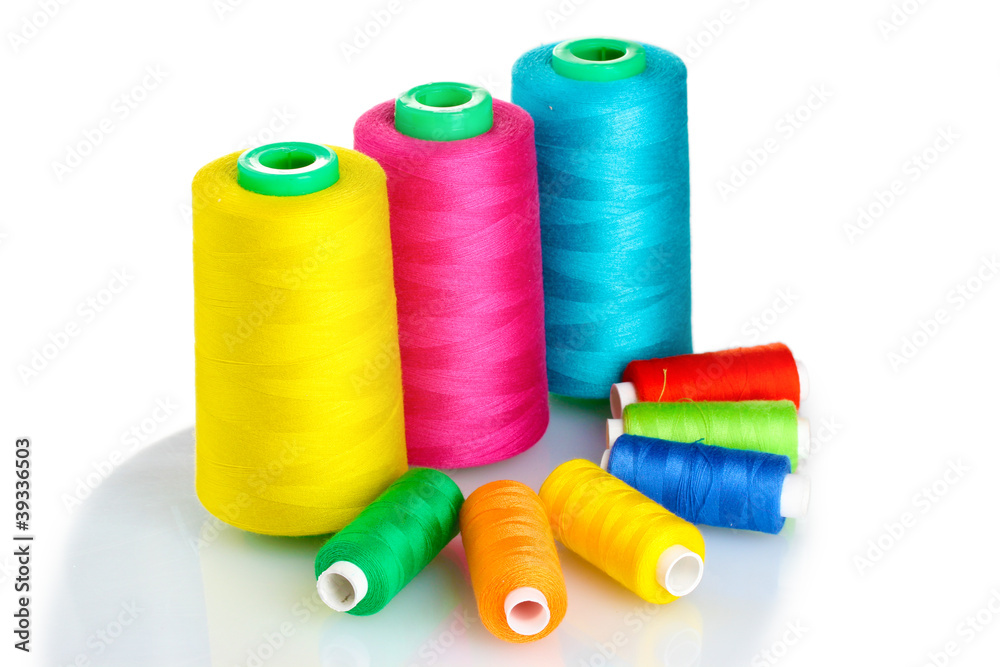 Many-coloured bobbins of thread isolated on white Many-coloured bobbins of thread isolated on white