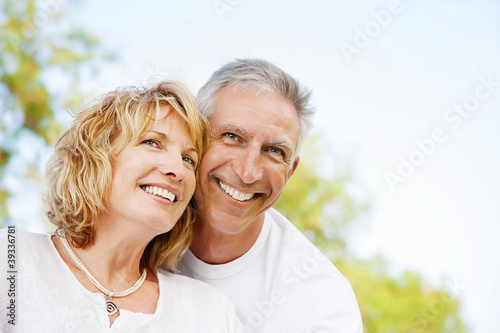 Mature couple smiling and embracing.