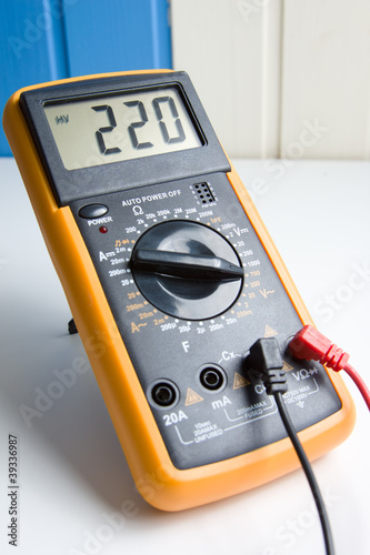 Digital multimeter showing 220 V