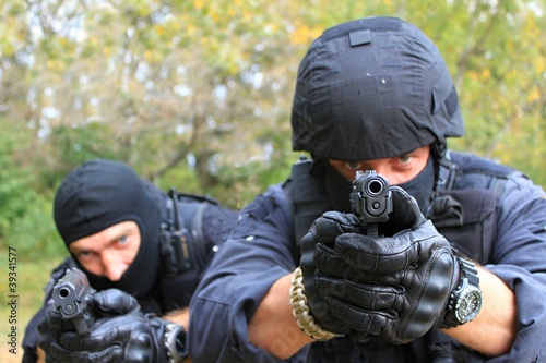 two armed policemen, aiming frontal view details