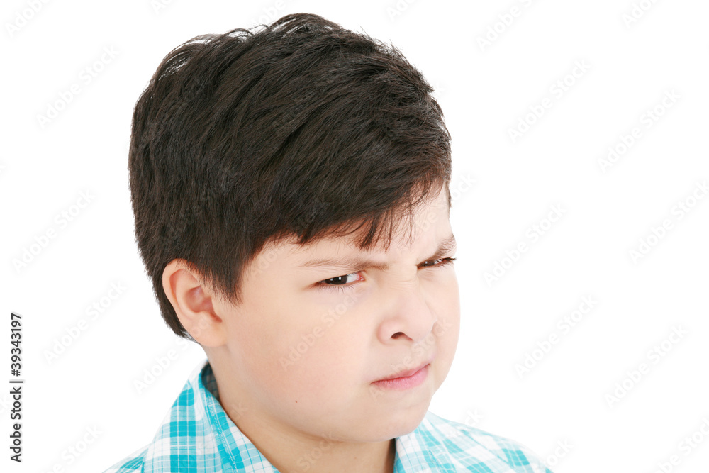Close-up portrait of angry little boy isolated on white backgrou Close-up portrait of angry little boy isolated on white backgrou