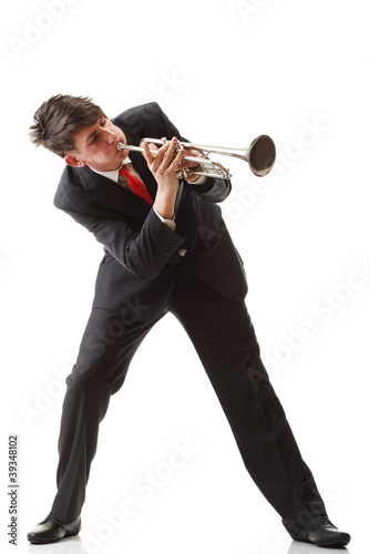 Portrait of a young man playing his Trumpet plays isolated white photo