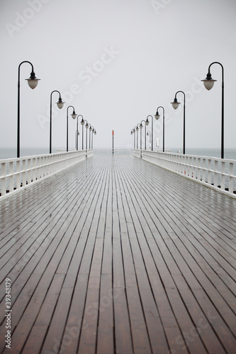 old pier in rain on Baltic sea Orlowo Gdynia Poland photo