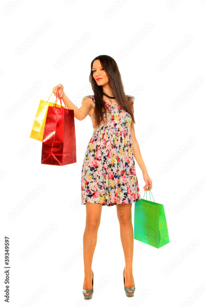 Portrait of stunning young woman carrying shopping bags