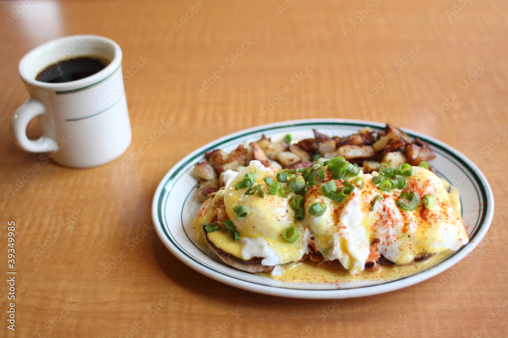 Eggs benedict with salmon and grilled potatoes. Eggs benedict with salmon and grilled potatoes.
