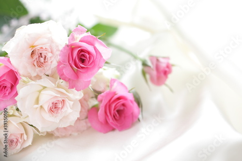 pink roses bouquet on white silk