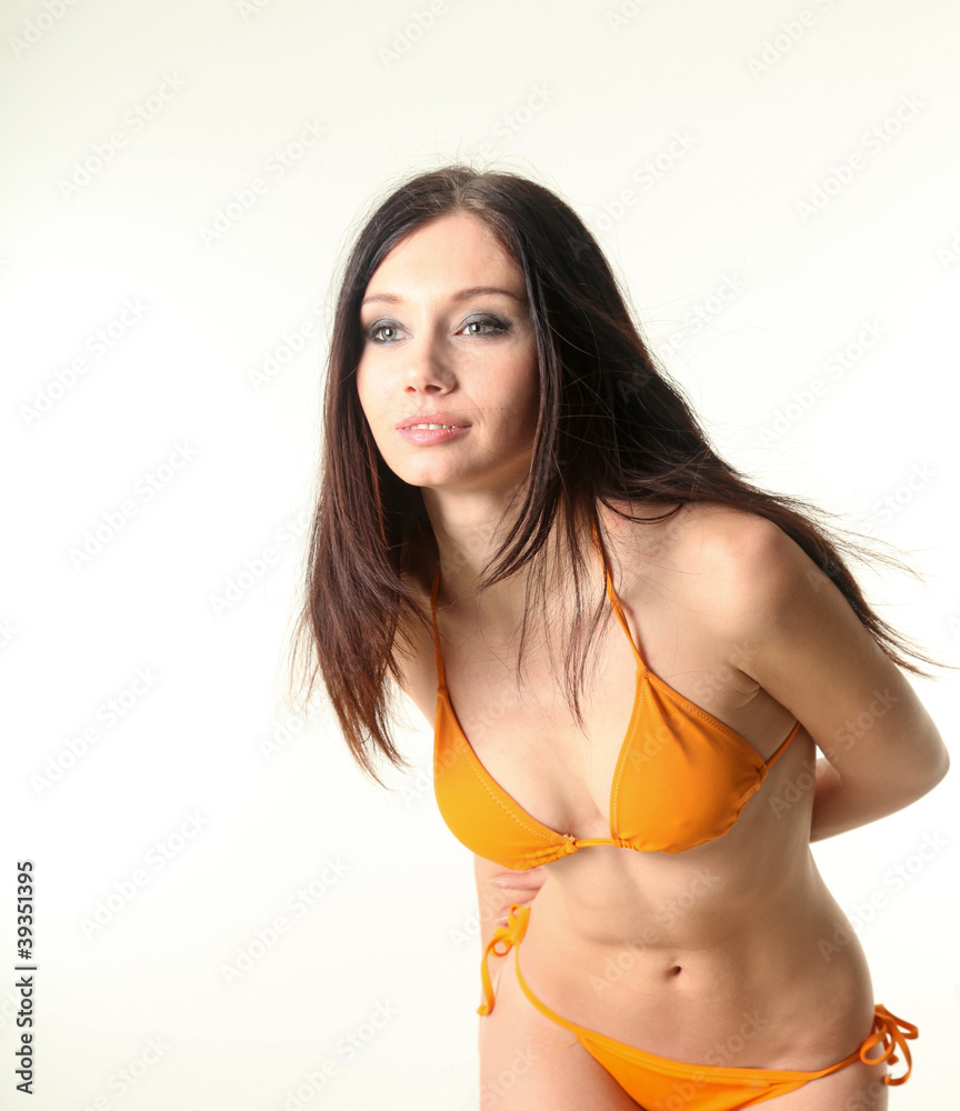 Obraz premium Young pretty slim woman wearing swimsuit over white