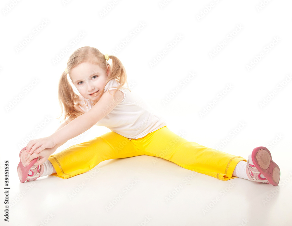 cute sly little girl doing gymnastic exercise cute sly little girl doing gymnastic exercise