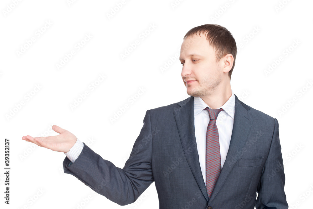 Young businessman in a suit presenting something isolated on whi Young businessman in a suit presenting something isolated on whi