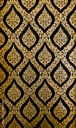 Golden Thai pattern on black wall