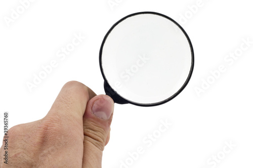 Magnifying glass holding human hand