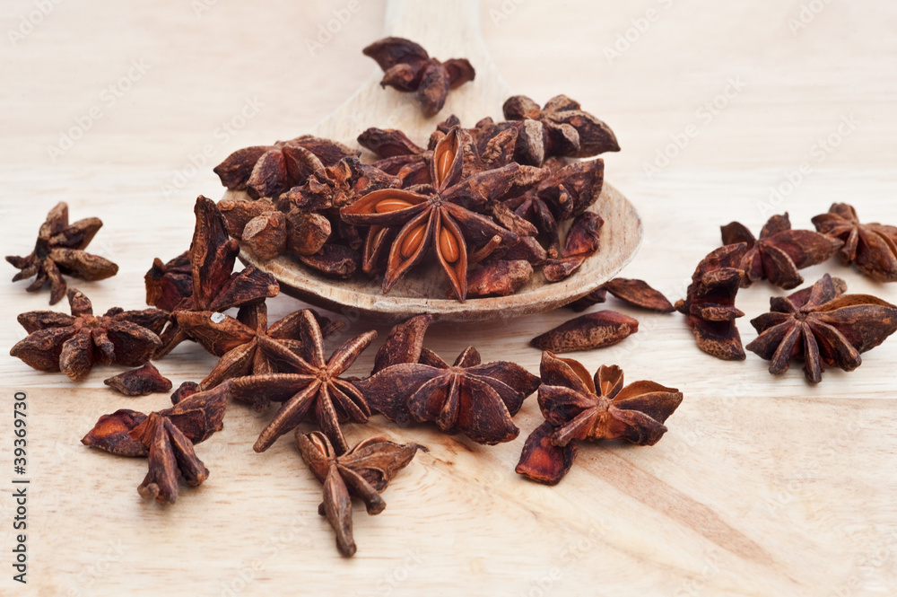 Star Anise on wooden serving spoon with selective focus Star Anise on wooden serving spoon with selective focus
