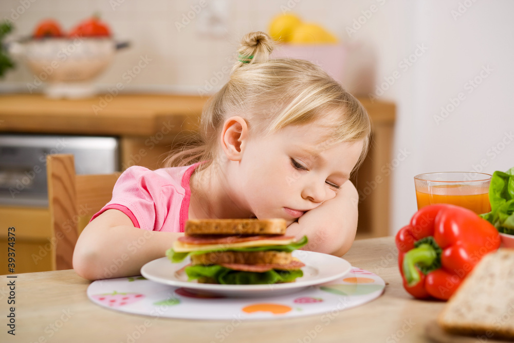 little girl eating? sandwich