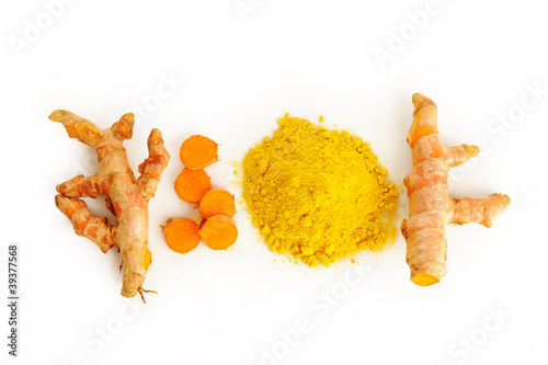 Turmeric root and powder on white