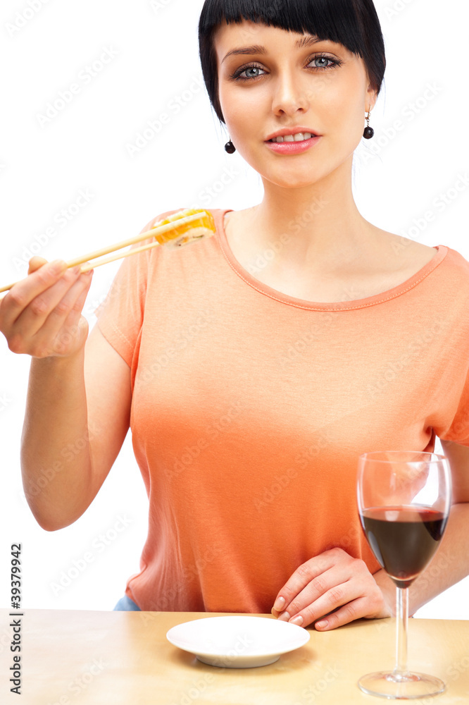Young woman eating sushi roll and drinking red wine Young woman eating sushi roll and drinking red wine