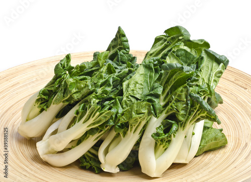 Bunch of Baby Bok Choy on a Bamboo Tray Isolated on White