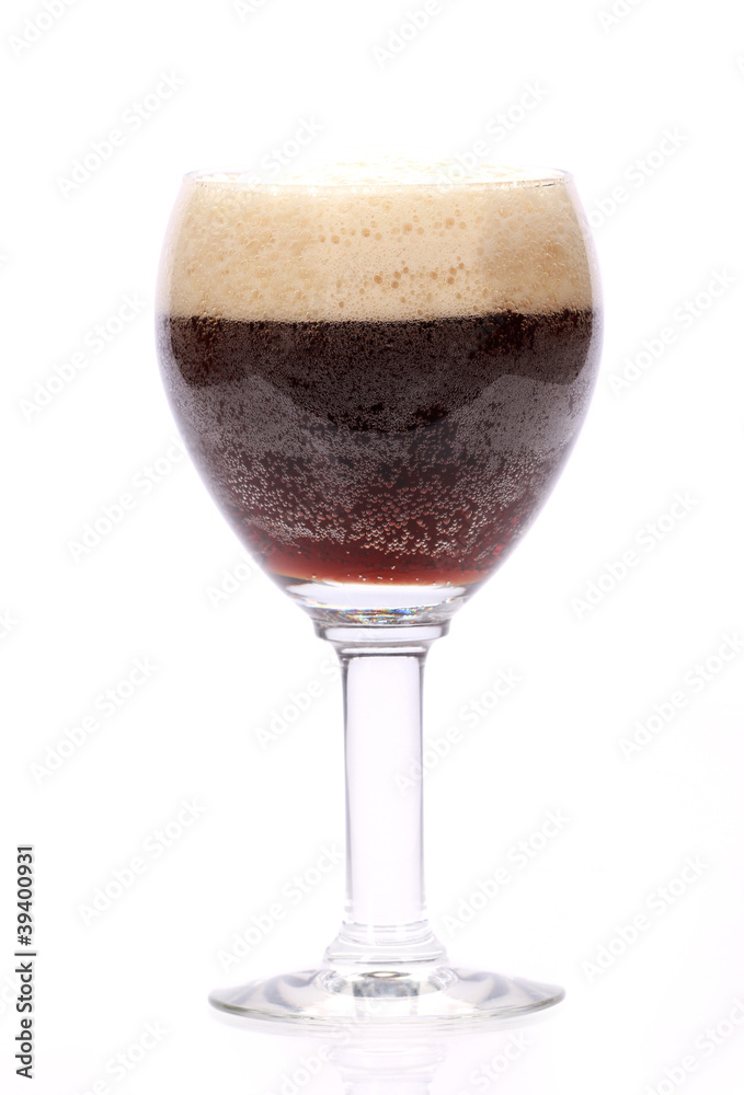 glass of a dark beer on a white background glass of a dark beer on a white background