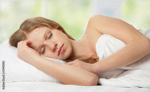 beautiful young woman sleeping in bed