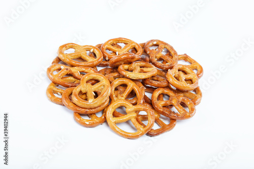 A handful of crunchy pretzels on a white background.
